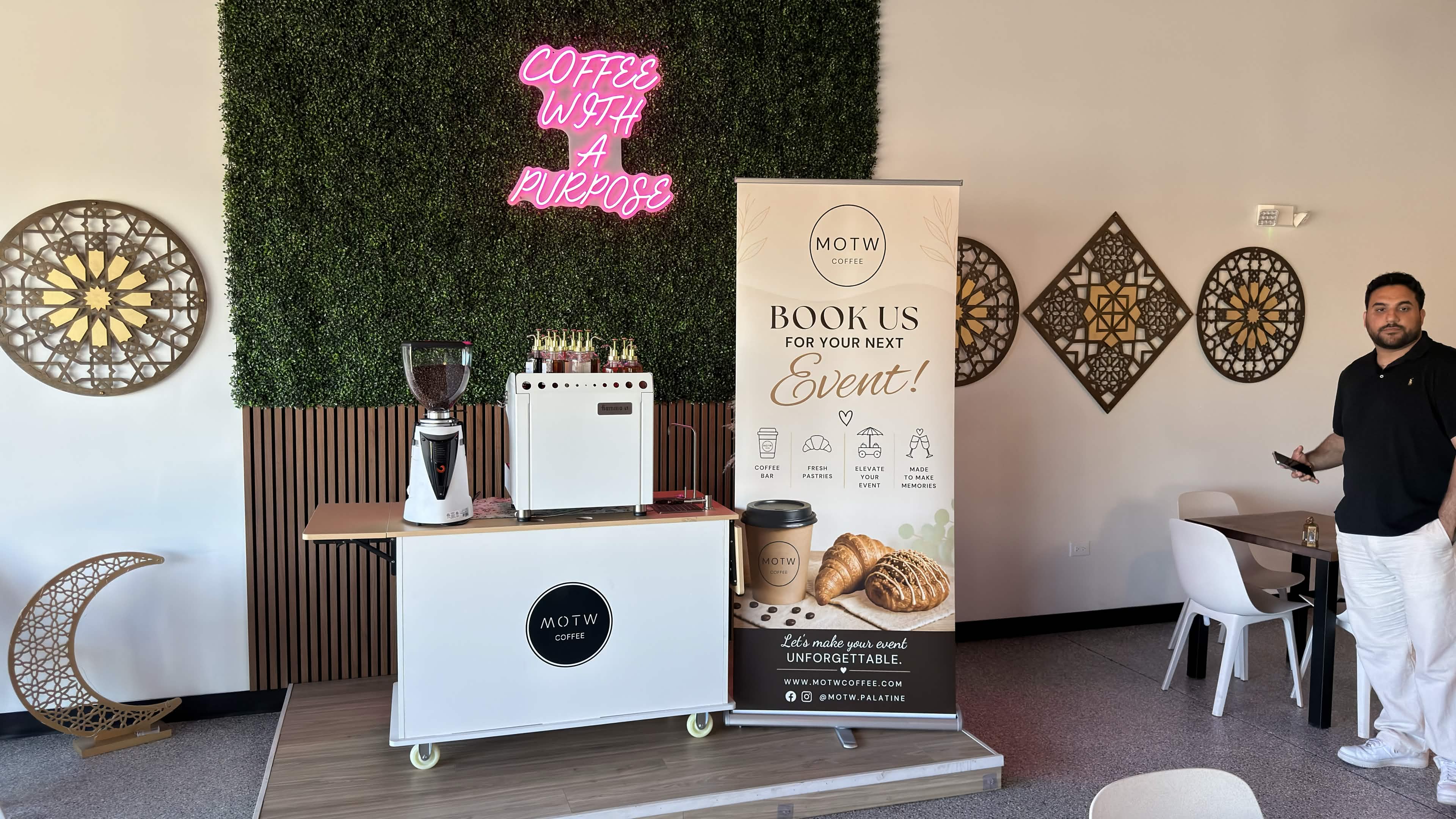 MOTW coffee cart with neon sign and event banner